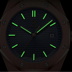 Tonneau-shaped watch with green glowing hands on a black background